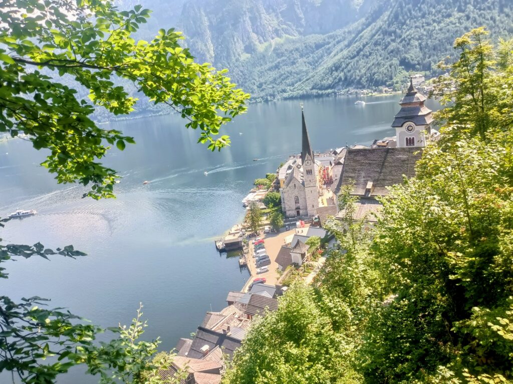 Elevated view of Hallstatt church and village nestled along the lake shore